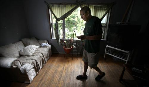 Still dependent on painkillers, (but out of supply and his doctor away) Bill DesJardin makes his way across his living room three weeks after surgery to replace his right knee. September 6, 2012 -(Phil Hossack / Winnipeg Free Press)