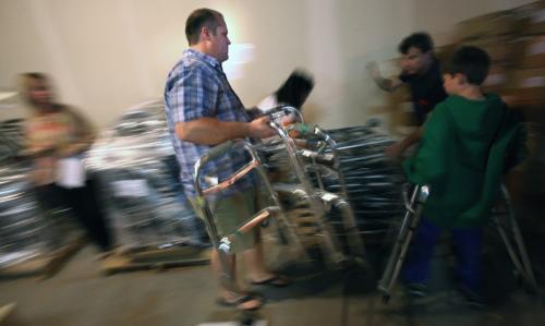 Surgical resident Dr David Ames helps sort ad haul gear to be shipped to Minagua for Operation Walk. Phil Hossack / Winnipeg Free Press August 27, 2012