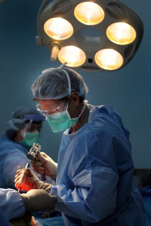 Operation Walk Surgeon David Heddon drives home part of a knee replacement  with a stainless steel mallet during surgery in Managua. Phil Hossack / Winnipeg Free Press October 25, 2012