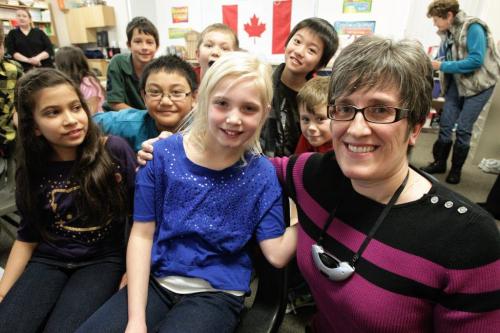 Sydney Stefanson (centre), 9, and her grade four teacher, Mary-Ann Mitchler, who is wearing one of the portable Frontrow microphones along with her classmates at Oakenwald School. 121122 November 22, 2012 Mike Deal / Winnipeg Free Press