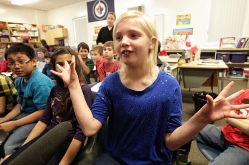 Hearing impaired grade four student, Sydney Stefanson (centre), 9, gestures while describing how the new school-wide sound system will help all the students at Oakenwald School not just her. 121122 November 22, 2012 Mike Deal / Winnipeg Free Press