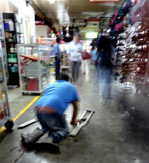 A badly crippled man makes his way on hands and knees through a Managua public market....Winnipeg's Operation Walk team arrived in the Nicaraguan Capitol to treat people like him who depend on their own mobility to survice in the central American country. Phil Hossack / Winnipeg Free Press October 25, 2012