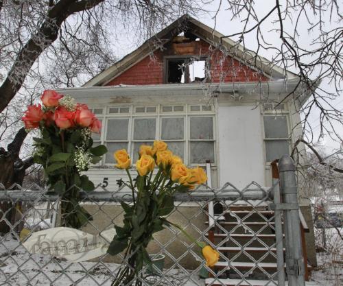 Flowers on the front fence of the home of Bert and Joanne Parry who died after fire broke out Thursday morning in their house on Hethrington Avenue. (WAYNE GLOWACKI/WINNIPEG FREE PRESS) Winnipeg Free Press  Winnipeg Free Press  Nov. 23   2012