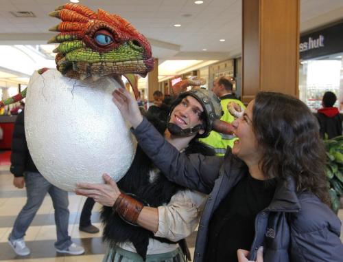 Meire Anne Thorarinson pets a dragon baby held by an actor Godefroy Ryckewaert, from Paris, France (plays the character
Snotlout) at Polo Park Shopping centre. How To Train Your Dragon Live Spectacular at the MTS Centre this weekend and they were in the mall trying to drum up some interest in the show. November 23, 2012  BORIS MINKEVICH / WINNIPEG FREE PRESS