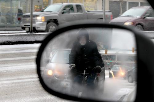 Pedestrians and cyclists make their way down Portage Ave. Saturday morning windy conditions and heavy snowfall. Standup photo Nov  24, 2012, Ruth Bonneville  (Ruth Bonneville /  Winnipeg Free Press)