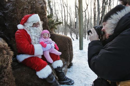 Emma, 7 months, has her photo taken by her father, Dan Leitch, with Santa in the forest at FortWhyte Alive Sunday morning.  121125 November 25, 2012 Mike Deal / Winnipeg Free Press