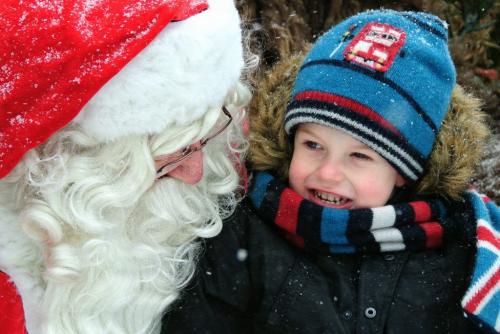 An excited, London Thompson, 3, gets his photo taken with Santa in the forest at FortWhyte Alive Sunday morning.  121125 November 25, 2012 Mike Deal / Winnipeg Free Press