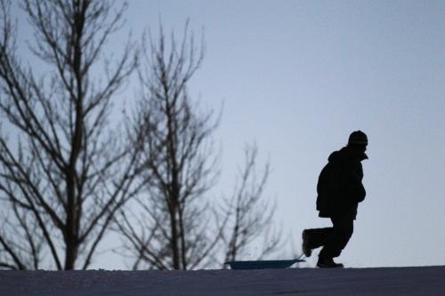 A young sledder climbs Garbage Hill to do some tobogganing Sunday, November 25, 2012. (John Woods/Winnipeg Free Press)