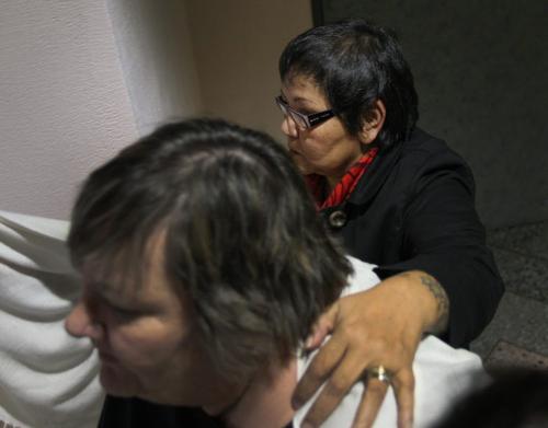 Delores Chief Abigosis, rear, a social worker testified today at the Phoenix Sinclair Inquiry Here her advocate tries to block her face while leaving the inquiry for a lunch break Monday- See Carol Sanders story- November 26, 2012   (JOE BRYKSA / WINNIPEG FREE PRESS)