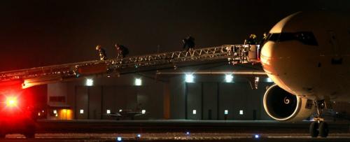 City firefighters lead a pair of occupants off a UPS Cargo flight that made an emergency landing in Winnipeg Tueday night. THe jumbo jet was surrounded by emergency vehicles on landing with a fire indicator light on. See story? January 31, 2012 - (Phil Hossack - Winnipeg Free Press)