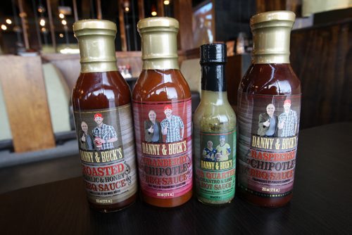 L to R  Dannys Whole Hog BBQ on Ellice Ave and Route 90  Selection of BQ sauce for sale with parnter  Winnipeg Blue Bomber QB Buck Pierce on label-See Marion Warhaft food review- November 27, 2012   (JOE BRYKSA / WINNIPEG FREE PRESS)