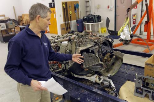 Transportation Safety Board of Canada Regional Manager Peter Hildebrand shows photographer the motor and propeller of the plane that crashed up north recently. The crash claimed the life of the pilot. November 27, 2012  BORIS MINKEVICH / WINNIPEG FREE PRESS