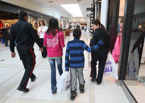 Const Jacqueline Picard, right, and Sargent Darryl Ramkisson, left,  of the Winnipeg Police Service take youths Bryden Duck, 9yrs, and Chantel Pierce shopping at Toys Are Us in St Vital Shopping Centre-The Winnipeg Police Service in collaboration with school divisions throughout the City of Winnipeg and the St. Vital Centre hosted the 6th Annual Winnipeg COPSHOP event. COPSHOP gives students the experience of an unforgettable day of shopping with a police officer(s). Students who participated in this event were selected their respective school divisions. The selection criterias for students are based on a need, specific academic or sporting achievements and volunteerism. About 60 youths took part in todays event-Standup photo- November 27, 2012   (JOE BRYKSA / WINNIPEG FREE PRESS)
