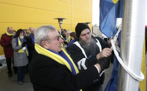 Swedish Consul General Neil Carlson (left) raises the Swedish flag with some help during the grand opening of Winnipeg's IKEA Wednesday morning. 121128 - Wednesday, November 28, 2012 -  (MIKE DEAL / WINNIPEG FREE PRESS)