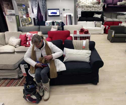 A customer sits on a couch after finally entering the store shortly after the grand opening of Winnipeg's IKEA Wednesday morning. 121128 - Wednesday, November 28, 2012 -  (MIKE DEAL / WINNIPEG FREE PRESS)
