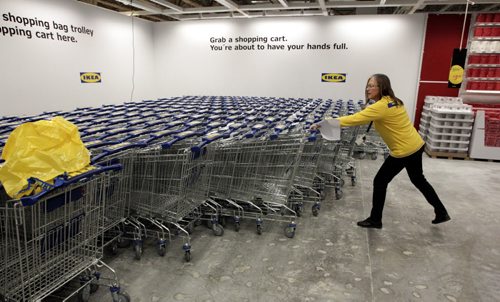 An employee organizes the shopping carts continuously shortly after the grand opening of Winnipeg's IKEA Wednesday morning. 121128 - Wednesday, November 28, 2012 -  (MIKE DEAL / WINNIPEG FREE PRESS)