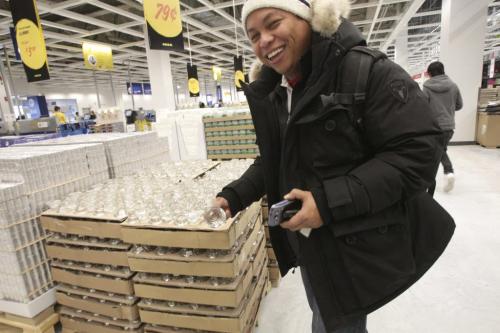 Ron Cantiveros of the Filipino Journal is the first of Winnipeg's Media to break something during the grand opening of Winnipeg's IKEA Wednesday morning. 121128 - Wednesday, November 28, 2012 -  (MIKE DEAL / WINNIPEG FREE PRESS)