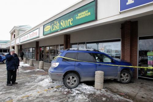 A woman was taken to hospital in unknown condition after her vehicle went through a concrete pylon and struck a building in the Dominion Centre shopping mall off of Marion Street Thursday morning.  121129 November 29, 2012 Mike Deal / Winnipeg Free Press