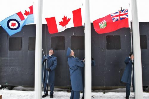Members of the Royal Canadian Air Force flag group raise the flags during the singing of the national anthem at the sign dedication at the entrance/exit to the airport on Wellington Avenue Thursday afternoon.  121129 November 29, 2012 Mike Deal / Winnipeg Free Press
deal2012poy