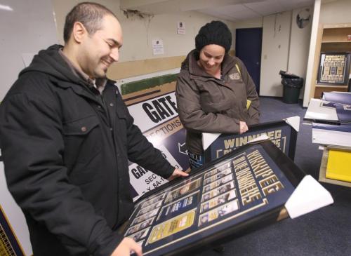 Winnipeg Blue Bomber season ticket holders Nichole Swain and Future brother Peter Combiadakis look at Bomber ticket frames they planned to buy at Canad Inns Stadium. Many other items and memorabilia  were for sale for season ticket holders until Dec 02 when the general public will be invited.-Standup Photo-November 29, 2012   (JOE BRYKSA / WINNIPEG FREE PRESS