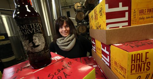 Nicole Rudge of "Half Pints" Brewery poses with some of their craft brewed product some of which is now exported to Ontario and BC....See story.. .....Phil Hossack / Winnipeg Free Press - December 12, 2012