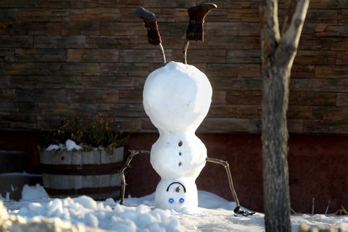 A snowman displays his acrobatic talents by standing on his head on Shepard Ave. Tuesday morning.  Now that's using your head.  Standup photo   Dec 04, 2012, Ruth Bonneville  (Ruth Bonneville /  Winnipeg Free Press)