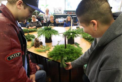 Students from Garden Valley Collegiate in Winkler came to the north end to RB Russel High school (RBH) to hear about RBRs apparently unique horticulture program. Here Garden Valley Collegiates Noah Olfert get some tips from RBH student Brittany Nurdock on how to make a Christmas centre piece- See Nick Martin story- December 05, 2012   (JOE BRYKSA / WINNIPEG FREE PRESS)