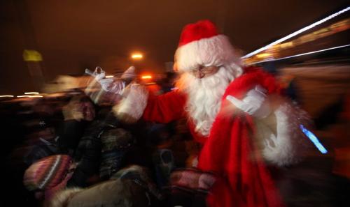 Santa hands out handfuls of candy canes Wednesday evening as the annual Holiday Train made it's stop in Winnipeg along Molson street en-route from Beaconsfiled Quebec to Port Moody BC, collecting cash and food donations along the way. See release. Dec 5, 2012 - Phil Hossack / Winnipeg Free Press.