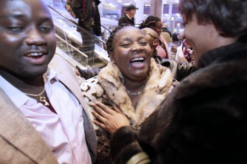 December 4, 2012 - 121204  -  Congolese refugee Esperance Safari (c) reacts as she is greeted by her nephew Baraka (L) and friends as she and her family arrive at Winnipeg's James Richardson International Airport Tuesday December 4, 2012. The family of nine fled the Congo in 2002 and have been sponsored into Canada by First Presbyterian Church. John Woods / Winnipeg Free Press
