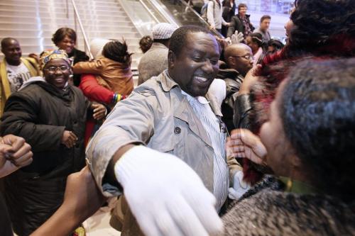 December 4, 2012 - 121204  -  Congolese refugee Bahati Mulimbwa is swarmed by friends and family as he and his family arrive at Winnipeg's James Richardson International Airport Tuesday December 4, 2012. The family of nine fled the Congo in 2002 and have been sponsored into Canada by First Presbyterian Church. John Woods / Winnipeg Free Press