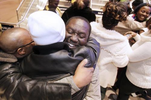 December 4, 2012 - 121204  -  Congolese refugee Bahati Mulimbwa (c)is swarmed by friends and family as he and his family arrive at Winnipeg's James Richardson International Airport Tuesday December 4, 2012. The family of nine fled the Congo in 2002 and have been sponsored into Canada by First Presbyterian Church. John Woods / Winnipeg Free Press