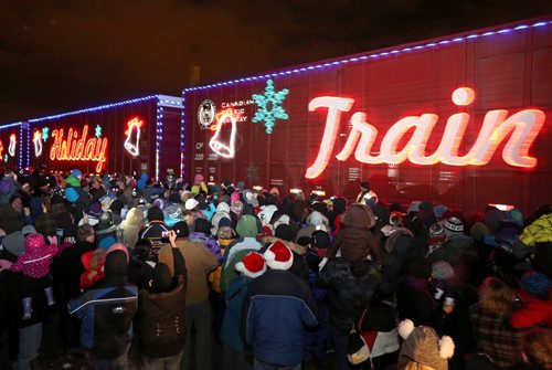 Brandon Sun Brandon greets the hundreds of thousands of LED lights adorning the Canadian Pacific Holiday Train, Thursday evening in Brandon. The train, in its 14th year, garnered donations of food to Samaritan House from Brandonites gathered to see performers Doc Walker and Miss Emily. (Colin Corneau/Brandon Sun)
