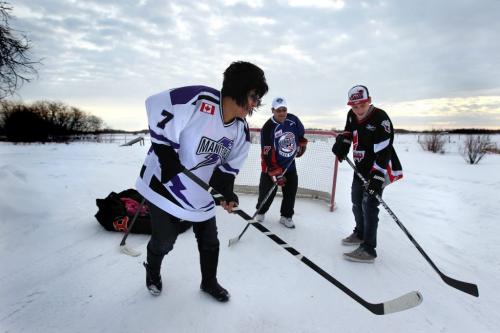 Farron Cochrane, his wife Pearl and their 15 year old son Christian enjoy and pick up game of hockey on their driveway in Pequis  First Nation.  The Cochrane family have nine children and with 6 of them playing hockey in local leagues.  See Randy Turner's Native, Aboriginal hockey story. Dec 05, 2012, Ruth Bonneville  (Ruth Bonneville /  Winnipeg Free Press)
