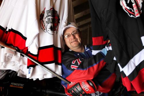 Farron Cochrane pauses for a quick photo in his shed next to dozens of jersey's hanging next to him on his property on Pequis First Nation. Cochrane has been like the grandfather of hockey in this community after coaching for years and helping his sons  play in leagues throughout the years around the province. See Randy Turner's Native, Aboriginal hockey story. Dec 05, 2012, Ruth Bonneville  (Ruth Bonneville /  Winnipeg Free Press)