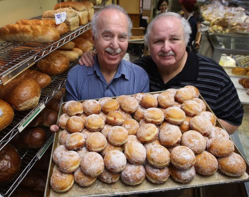 Holiday treats- Bernie Gunn,left, and his brother Fivie of Gunn's Bakery, with a tray of sufganiot, or jambusters, which are a traditional treat eaten during the eight-day festival of lights, or Hanukkah, which begins at sundown Saturday.-Gunns is also celebrating their 75th anniversary this year as a company- Standup Photo- December 07, 2012   (JOE BRYKSA / WINNIPEG FREE PRESS)