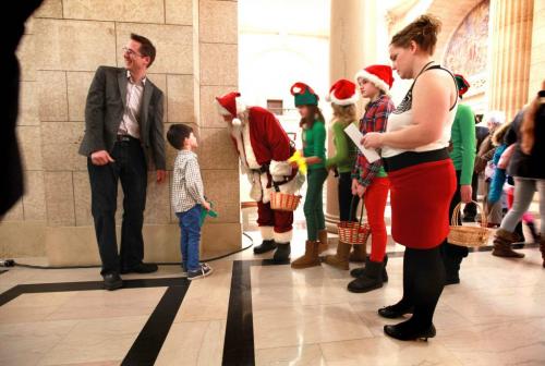 A young boy stops Santa and his elves in the hallway to talk with him during the Manitoba legislature's  annual open house on Saturday afternoon.   Standup weather photo. Dec 08, 2012, Ruth Bonneville  (Ruth Bonneville /  Winnipeg Free Press)
