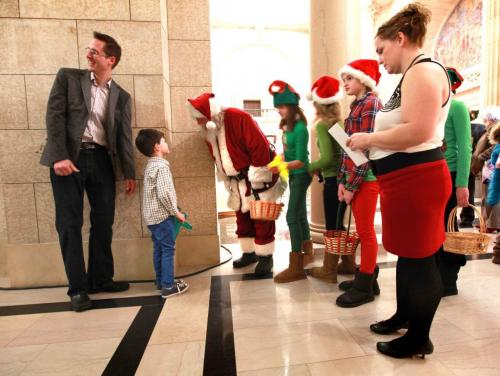 A young boy stops Santa and his elves in the hallway to talk with him during the Manitoba legislature's  annual open house on Saturday afternoon.   Standup weather photo. Dec 08, 2012, Ruth Bonneville  (Ruth Bonneville /  Winnipeg Free Press)