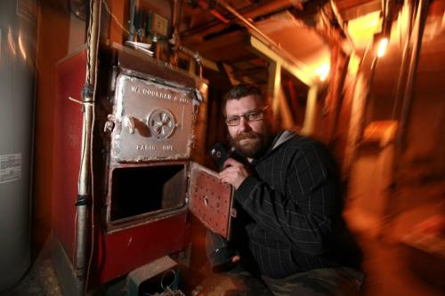 Cory Ciunyk is next to a boiler in the basement of a home that he rents a suite from  that hasn't been working for 4 days.  Since there is no heat coming from the boiler he has to try and supplement it with a little heater and the stove just to stay warm. See Carol Sander's story. Dec 08, 2012, Ruth Bonneville  (Ruth Bonneville /  Winnipeg Free Press)
