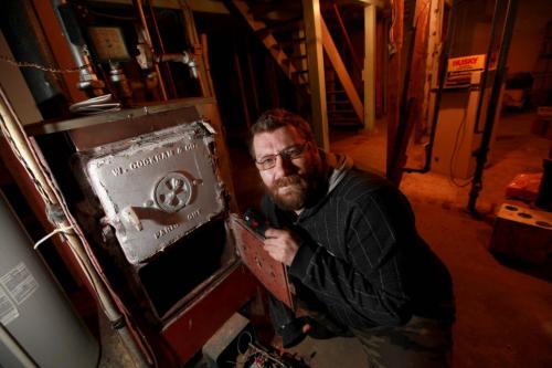 Cory Ciunyk is next to a boiler in the basement of a home that he rents a suite from  that hasn't been working for 4 days.  Since there is no heat coming from the boiler he has to try and supplement it with a little heater and the stove just to stay warm. See Carol Sander's story. Dec 08, 2012, Ruth Bonneville  (Ruth Bonneville /  Winnipeg Free Press)