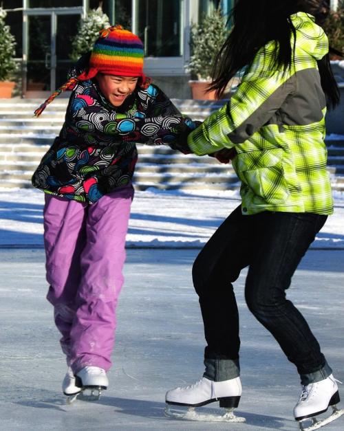 Chantal Ip, 10, and Kai Lee, 12, skate at The Forks skating pond Sunday morning.  121209 December 09, 2012 Mike Deal / Winnipeg Free Press