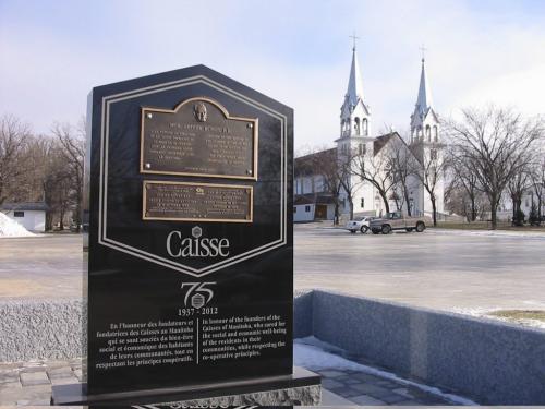Monument erected last month to mark the 75th anniversary of the first credit union in Manitoba, established in St. Malo. In some shots the St. Malo Catholic Church is in the background. The church's former priest, Father Arthur Benoit,  whose cameo portrait is in the monument, founded the caisse next door to the church and the church remained very much involved. December 4 2012. Bill Redekop story / photo. Winnipeg Free Press.