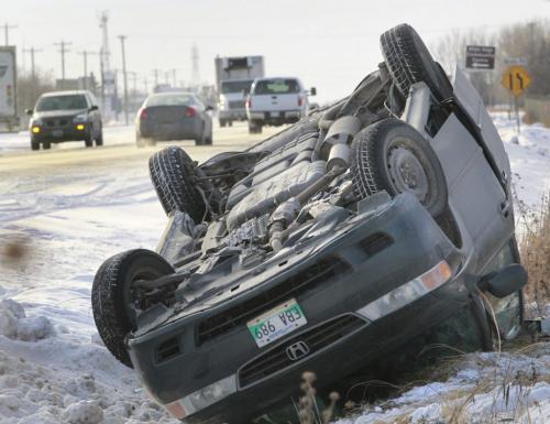 An over turned van on McGillivray Blvd. near Brady Rd. in the ditch waits for the tow truck's hook Monday afternoon.  Police on the scene didn't know the condition of occupants that were in the van. This was one of many traffic mishaps Monday.   (WAYNE GLOWACKI/WINNIPEG FREE PRESS) Winnipeg Free Press  Dec.10   2012