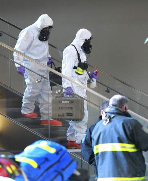 Winnipeg fire department's hazardous material unit members descend from the second floor office of the Manitoba Hydro office tower on Portage Ave. Tuesday after a suspicious package was placed in the drop off box. Employees nearby the office  were evacuated as the building remained open to the public.  (WAYNE GLOWACKI/WINNIPEG FREE PRESS) Winnipeg Free Press  Dec.11   2012