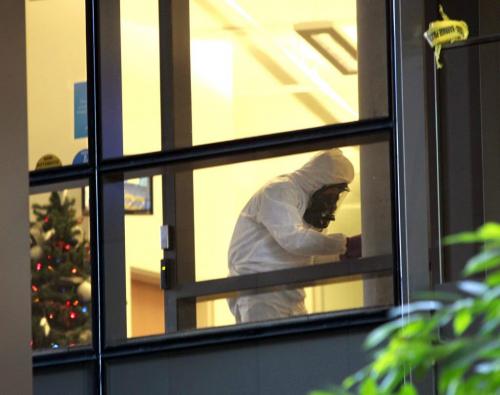 A member of the Winnipeg fire department's hazardous material unit works in an office on the second floor office of the Manitoba Hydro office tower on Portage Ave. Tuesday after a suspicious package was placed in the drop off box. Employees nearby the office were evacuated as the building remained open to the public.  (WAYNE GLOWACKI/WINNIPEG FREE PRESS) Winnipeg Free Press  Dec.11   2012
