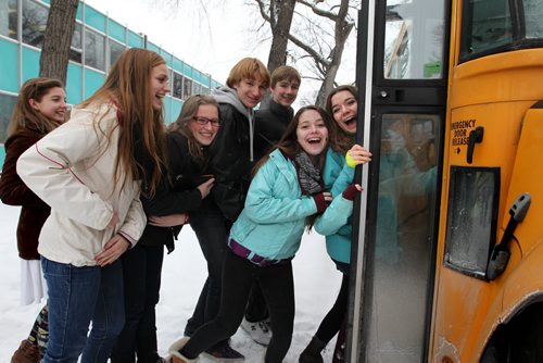 In the spirit of the season, students from the Kelvin High School choral program jump from the steps of  the  Child Guidance Clinic  700 Elgin Avenue Wednesday afternoon and board a school bus after carolling to the staff and visitors at the centre.  This was just one of several stops the bus made in support for the Christmas Cheer Board.  Non-perishable food items, toys and cash were collected for the Cheer Board during the drive to help those in need during the holiday season. Standup photo   Dec 12, 2012, Ruth Bonneville  (Ruth Bonneville /  Winnipeg Free Press)