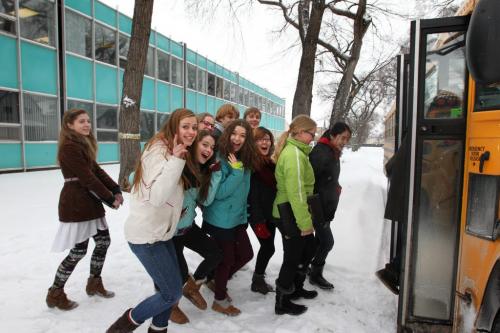 In the spirit of the season, students from the Kelvin High School choral program jump from the steps of  the  Child Guidance Clinic  700 Elgin Avenue Wednesday afternoon and board a school bus after carolling to the staff and visitors at the centre.  This was just one of several stops the bus made in support for the Christmas Cheer Board.  Non-perishable food items, toys and cash were collected for the Cheer Board during the drive to help those in need during the holiday season. Standup photo   Dec 12, 2012, Ruth Bonneville  (Ruth Bonneville /  Winnipeg Free Press)