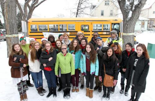 In the spirit of the season, students from the Kelvin High School choral program pose for the camera after singing a quick number just outside   the  Child Guidance Clinic  700 Elgin Avenue Wednesday afternoon. This was just one of several stops the bus made to bring some Christmas cheer by carolling to staff in support for the Christmas Cheer Board.  Non-perishable food items, toys and cash were collected for the Cheer Board during the drive to help those in need during the holiday season. Standup photo   Dec 12, 2012, Ruth Bonneville  (Ruth Bonneville /  Winnipeg Free Press)
