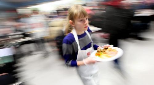 Eleven year old Carly Bell heads out with a heaping platter of cheer for the  third sitting at the Salvation Army Booth Center at Henry and Main Wednesday evening. 40 20lb turkeys, 300lbs of Mashed spuds, 15 gallons of gravy, 300 lbs of black forest ham, 300lbs of vegitables, 100 dozen dinner rols and 400 chocolate and cream pies were served in the four sittings between 430 and 730pm at the annual event See release. December12, 2012 - (Phil Hossack / Winnipeg Free Press)
