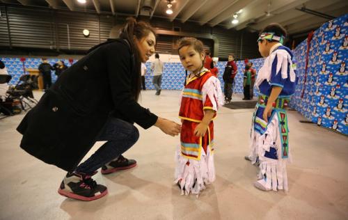 Kristen Bear adjusts the outfits worn by her sons, Kashis Desjarlais, 2, and Jayden Desjarlais, 5, at Kids Pow Wow Club, at the Ma Mawi Wi Chi Itata Centre, Wednesday, December 12, 2012. (TREVOR HAGAN/WINNIPEG FREE PRESS) - december 29 fyi