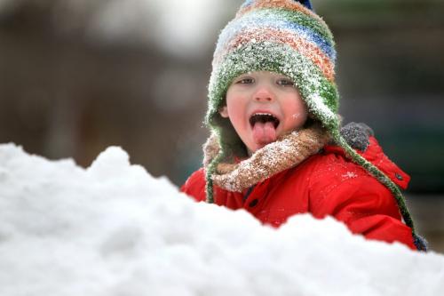 Three year old Mattejas Kafka licks the snow on his scarf as he makes his way up a snow hill at the Forks Thursday afternoon with his family. Standup photo. Dec 13, 2012, Ruth Bonneville  (Ruth Bonneville /  Winnipeg Free Press)